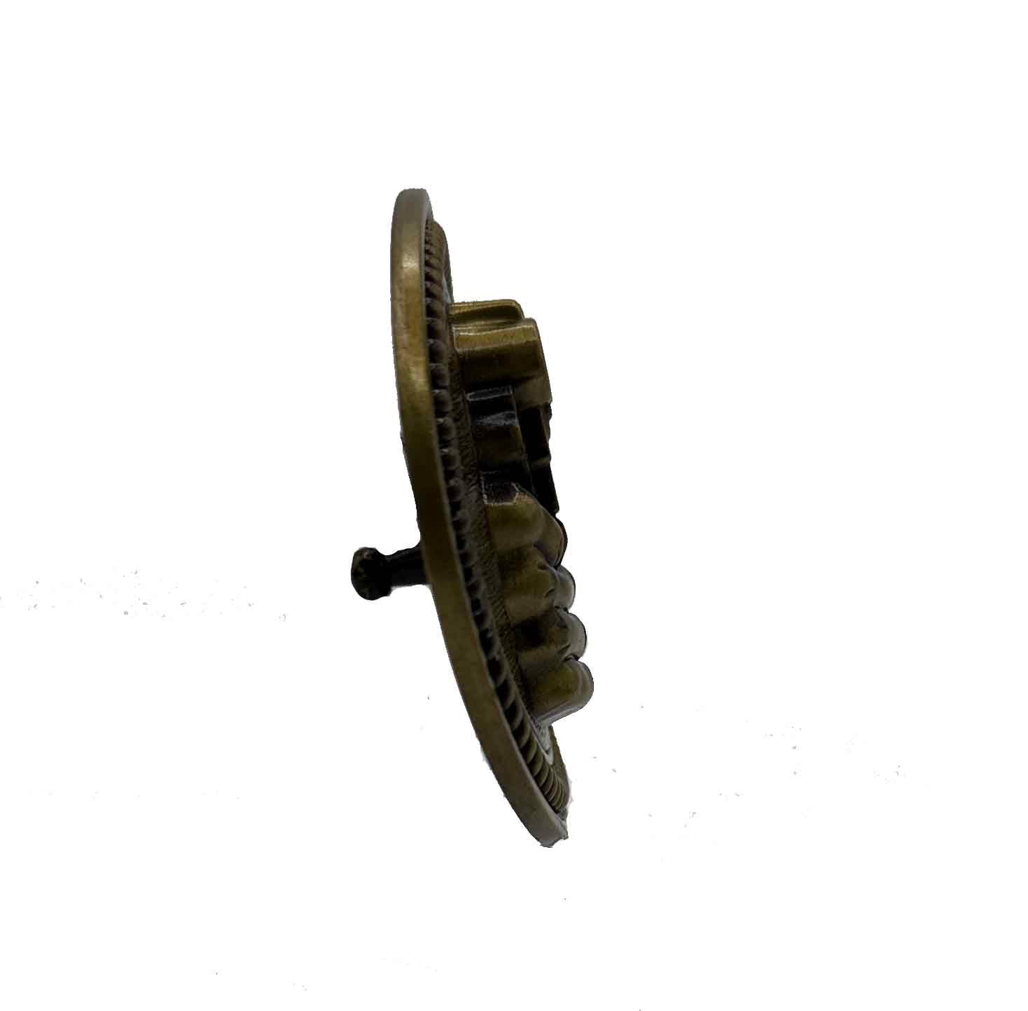 Antique gold-tone gun safety belt buckle with raised revolver and "The First Rule of Gun Safety: Don’t Piss Me Off!" text