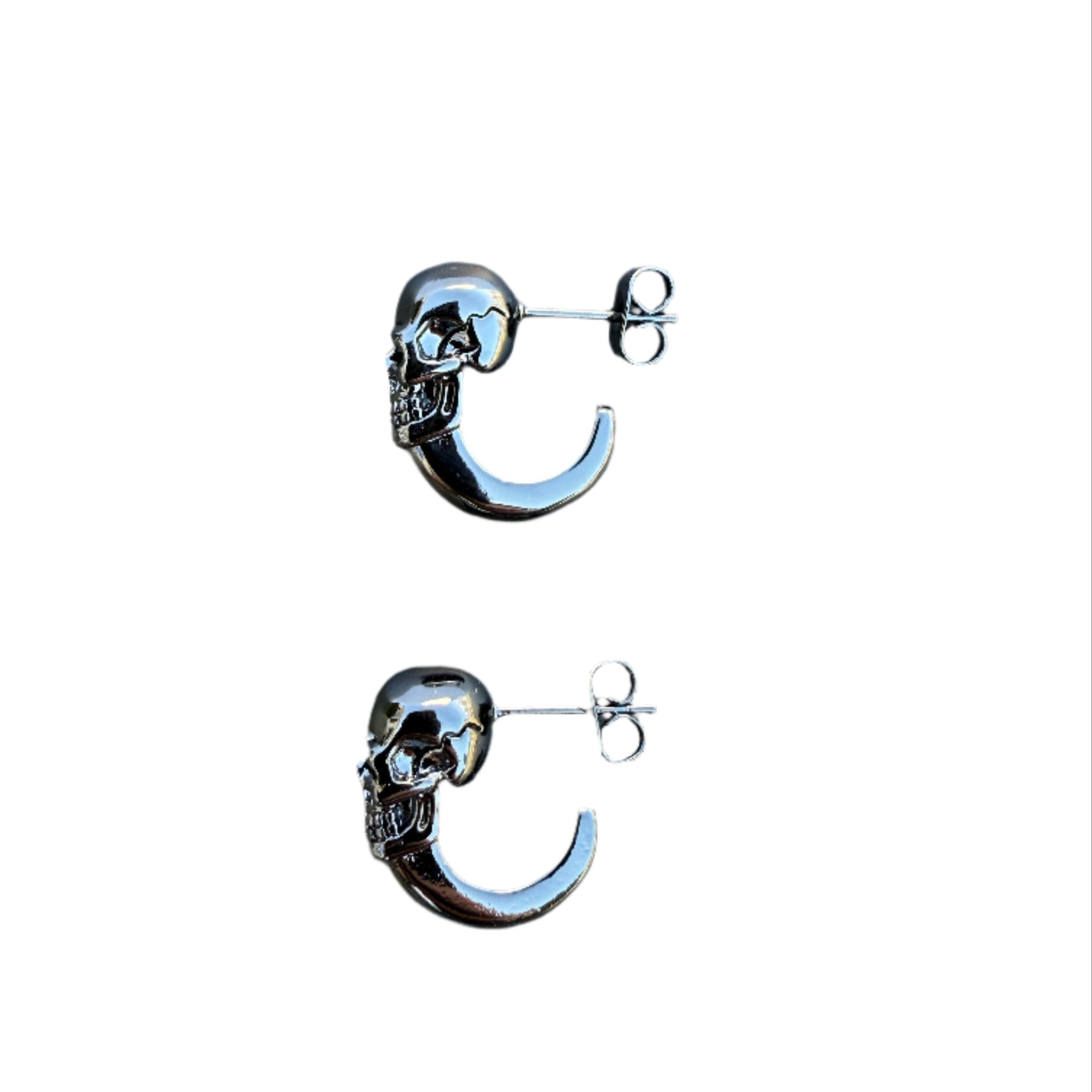 Unisex stainless steel skull earrings with hoop design.